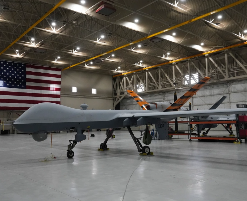 Four titanium springs in front of a motorized spring tester